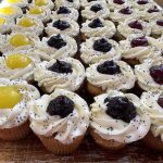 Poppyseed cupcakes topped with cream cheese and lemon