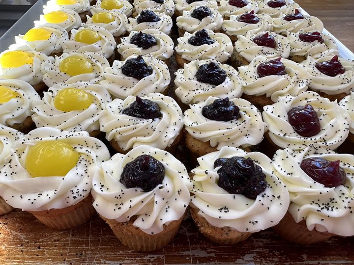 Poppyseed cupcakes topped with cream cheese and lemon
