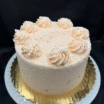 White chocolate cake with orange French icing and filling