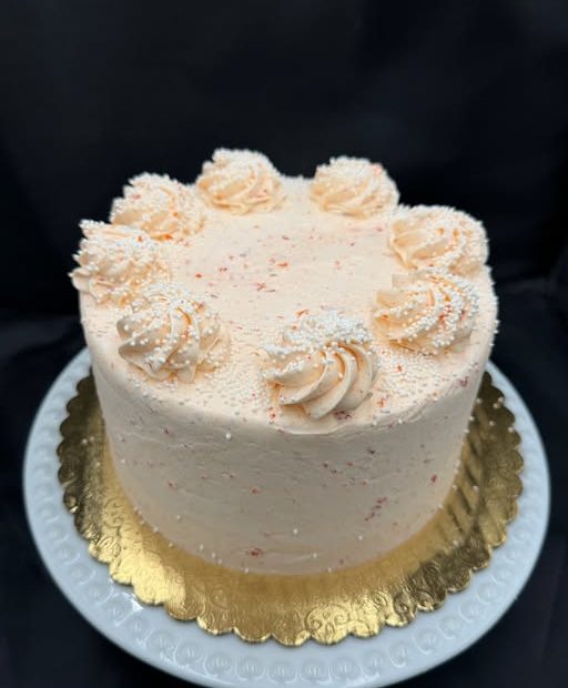 White chocolate cake with orange French icing and filling