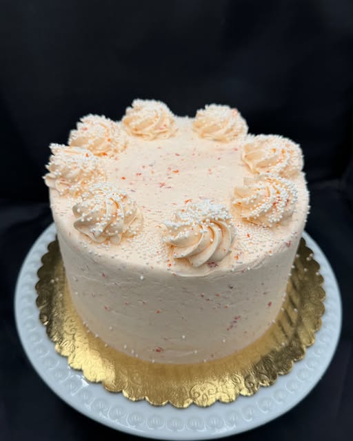 White chocolate cake with orange French icing and filling